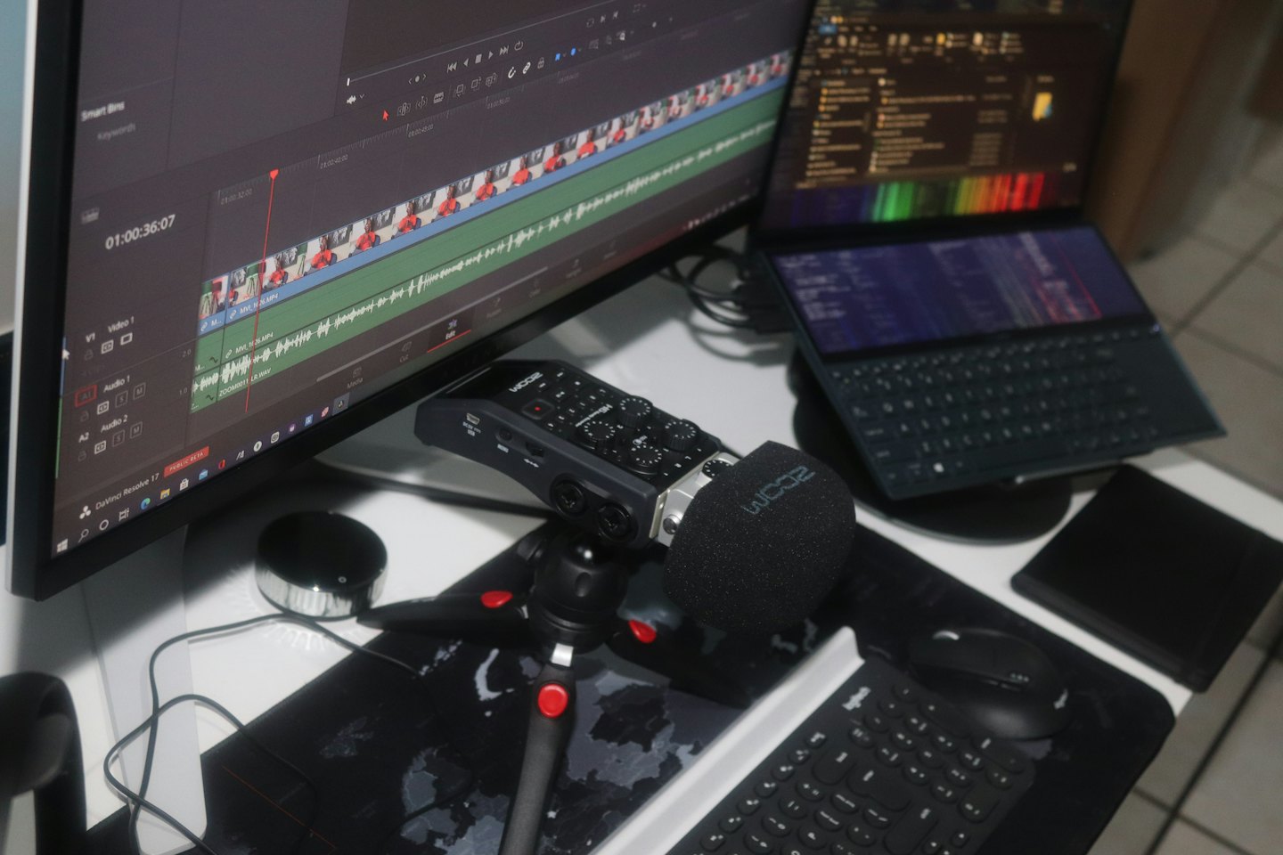 Professional workstation with video editing software on monitor.