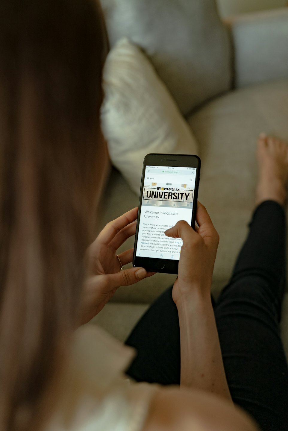 Person looking at Mometrix University website on smartphone.